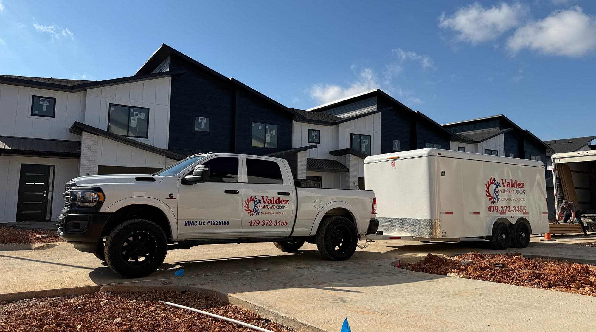 VALDEZ HVAC truck with trailer at a job site